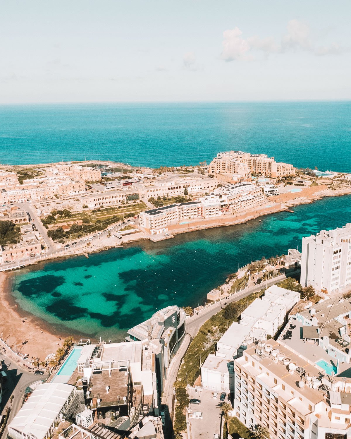 st.-julians-malta Vista do alto, St. Julian's em Malta revela uma paisagem encantadora, onde os edifícios de cores claras se erguem contra o mar azul.